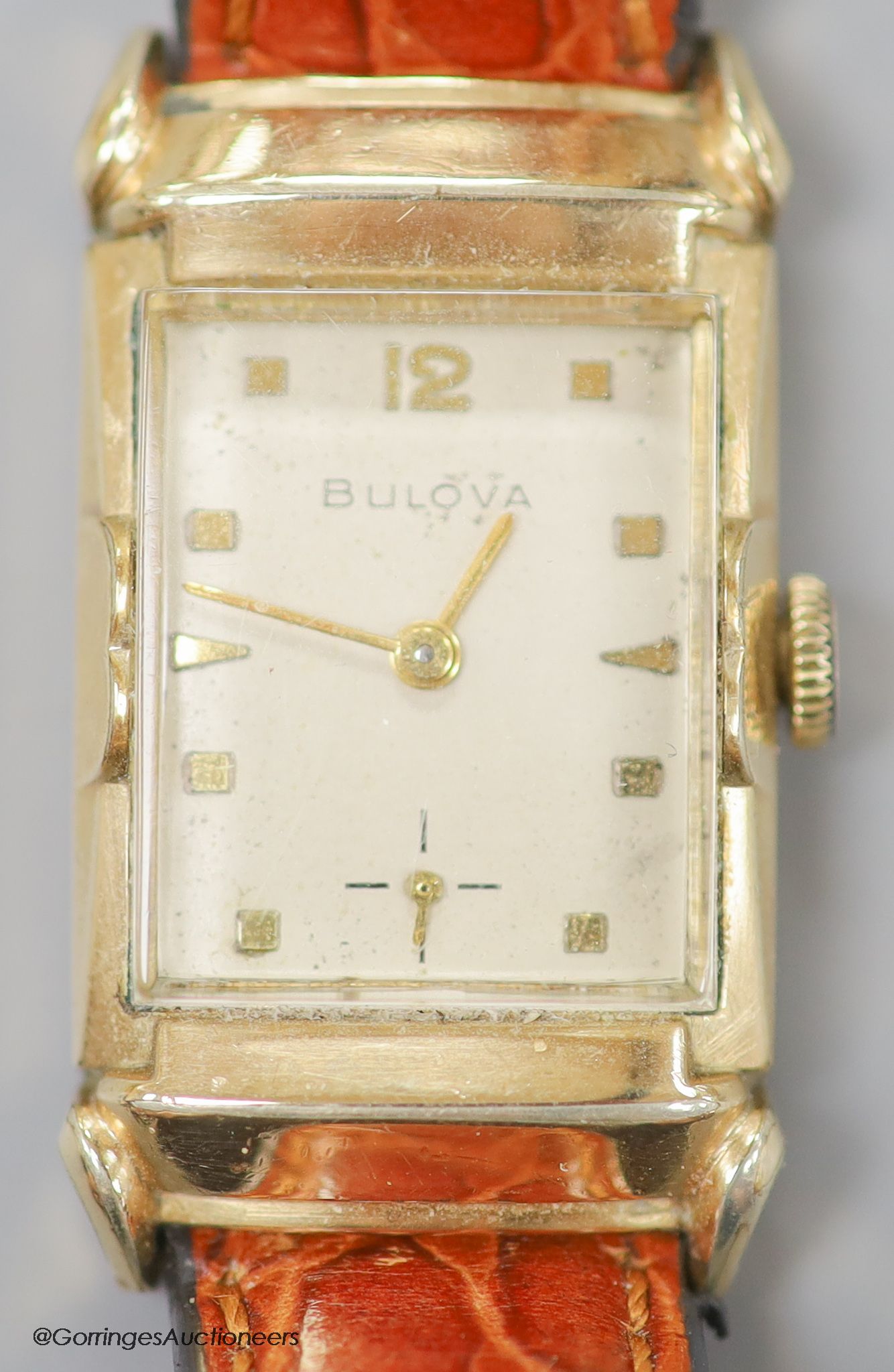A gentleman's 1930's 10k rolled gold Bulova manual wind rectangular dial wrist watch, with subsidiary seconds, on later leather strap.